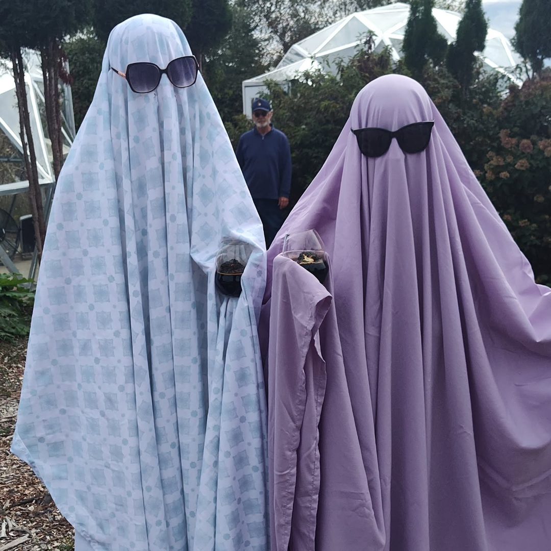 Two bedsheet ghosts in sunglasses, one blue and one lavender, at Burnt Marshmallow Brewstillery